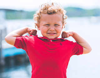 Preschool boy showing how strong he is